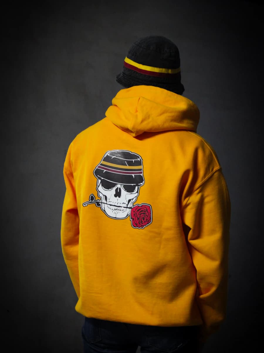 Adult model style reference — person in yellow and black hoodie