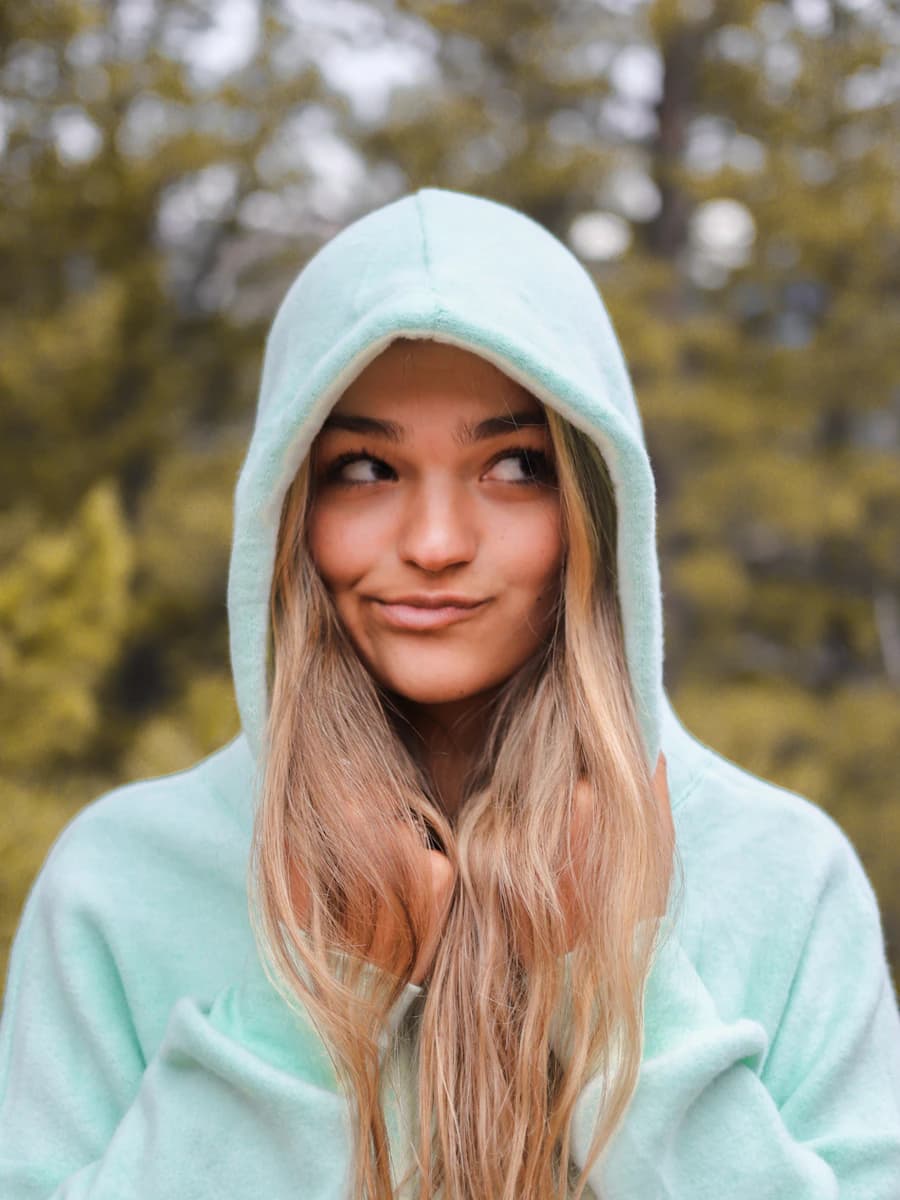 Adult model style reference — woman in white hoodie smiling